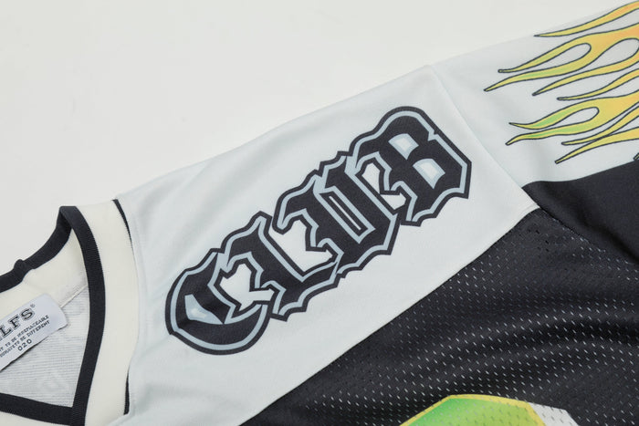 Close-up of a white and black football jersey with bold number 23 and yellow flame graphics on the sleeve
