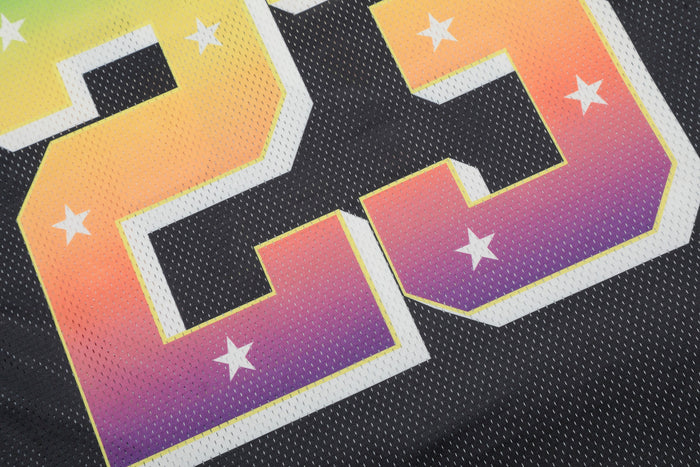 Close-up of a black football jersey with a large rainbow gradient number 23 and white star accents