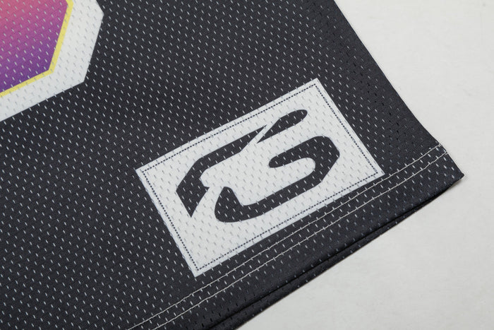 Black football jersey hem with stitched white number 23 patch and rainbow gradient trim detail