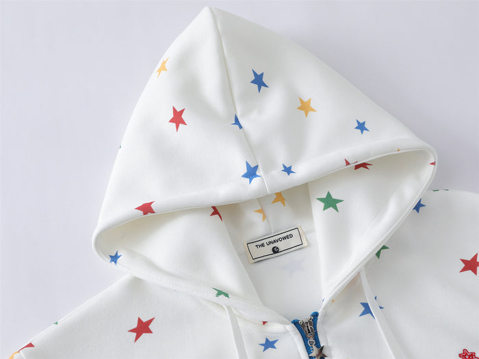 Close-up of the white star-print hood showing its folded edge, inner label, and soft textured fabric