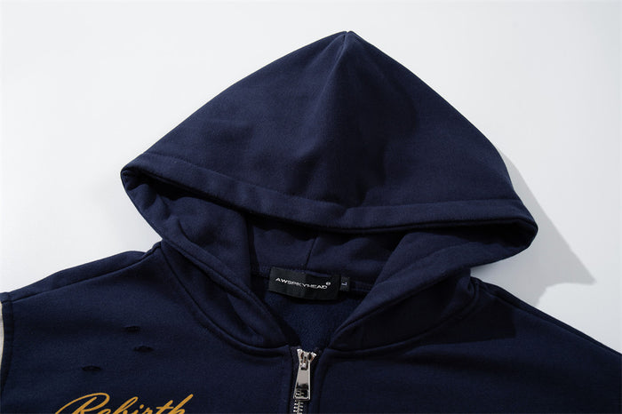 Close-up of the navy hood, drawstring area, neckline label, and silver front zipper
