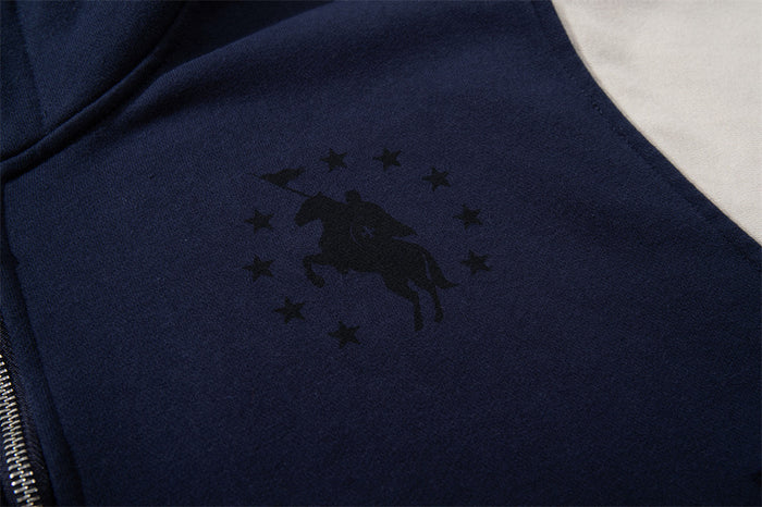Close-up of a black horse-and-stars graphic on the navy chest panel beside the zipper