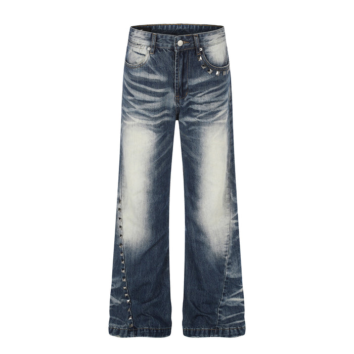 Front view of vintage wash wide-leg jeans with studded side seam and faded blue denim