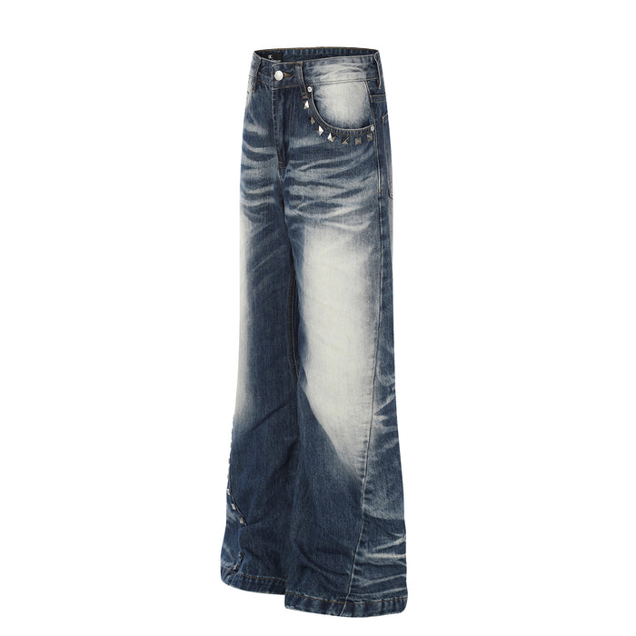 Angled front view of wide-leg vintage wash jeans with studded pocket detail and faded denim