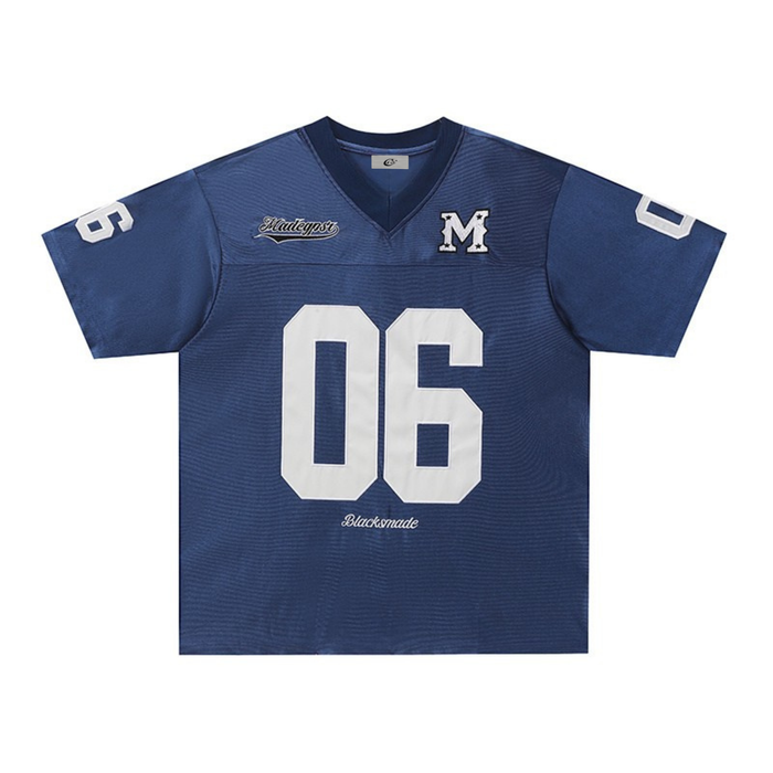 Navy retro football jersey tee with white number 06, varsity M patch, and streetwear styling on a V-neck shirt