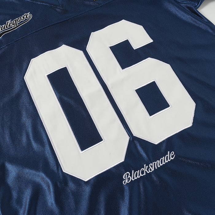 Navy retro football jersey tee with large white 06 varsity number and Blacksnmade script detail