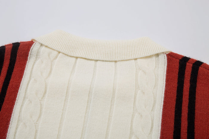 Close-up of cream ribbed collar and cable-knit yoke with red striped shoulders