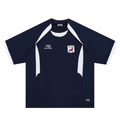 Flat lay of navy oversized football jersey with white contrast panels, red piping, and embroidered Remarkable shield crest on