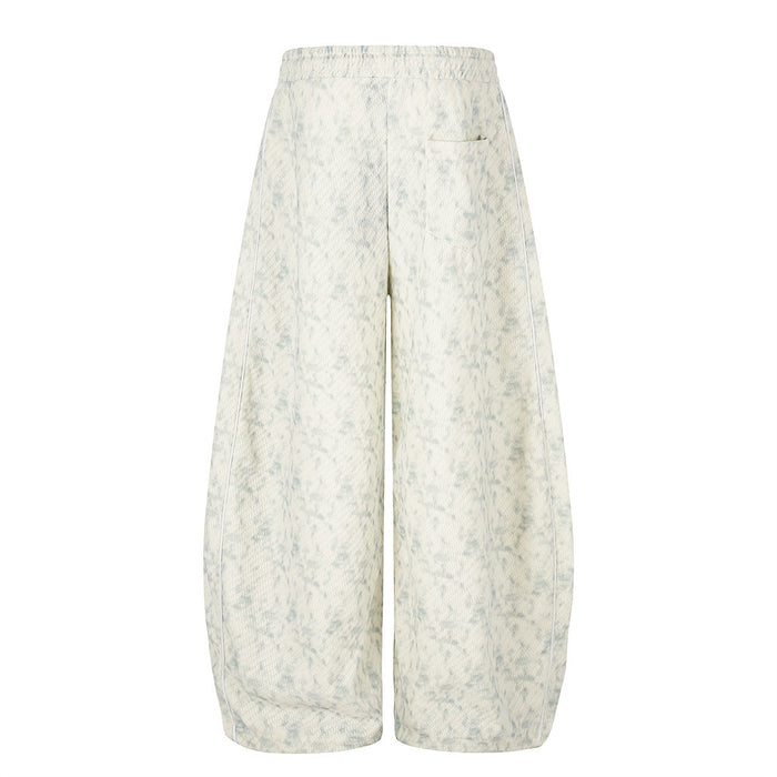 Back view of acid wash wide-leg sweatpants with a rear pocket and light blue speckled finish