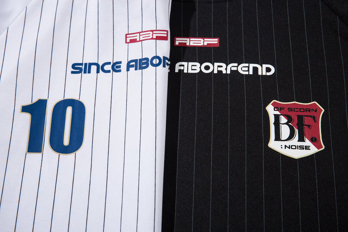 Close-up of front chest graphics on white and black pinstripe football jerseys
