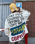 Person wearing cream oversized waffle long sleeve with COPYCAT WAR distressed back graphic and NY Yankees cap