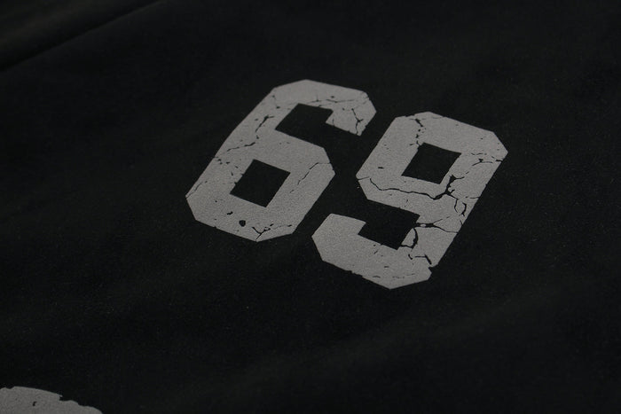 Close-up of 69 graphic printed in cracked gray on black hoodie chest
