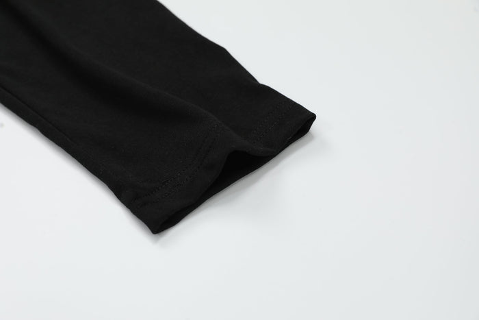 Black sleeve cuff detail with stitched hem on long sleeve top