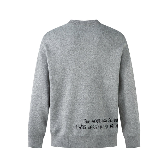 Back view of gray knit sweater with plain surface and small black text graphic near the lower hem