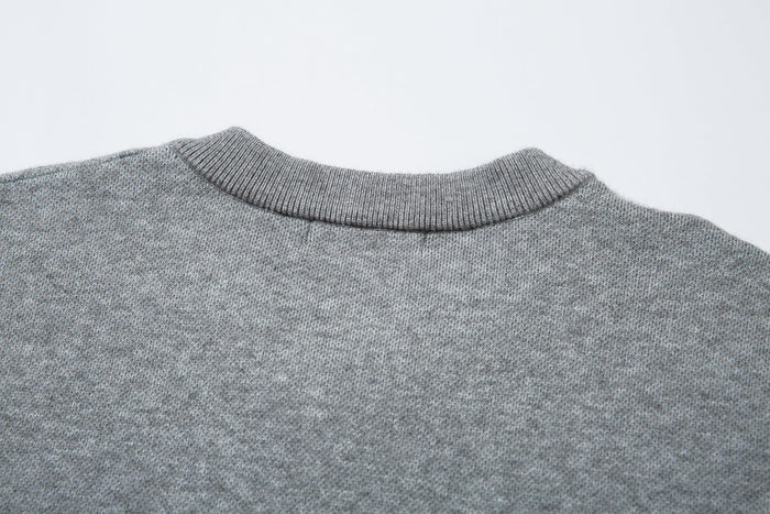 Close-up of the sweater back neckline showing ribbed gray V-neck knit texture