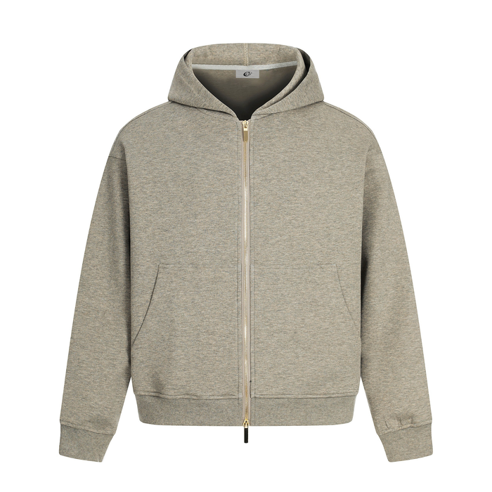 Beige zip-up hoodie with hood, front pockets, and gold zipper on a white background