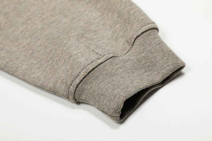 Beige hoodie sleeve cuff with ribbed knit trim and stitched seam detail
