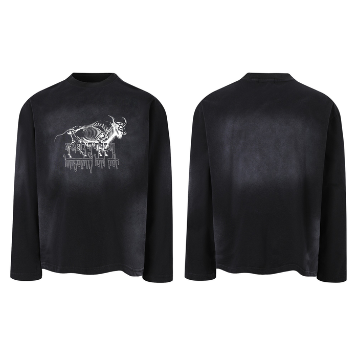 Black gradient washed long-sleeve tee with white skeletal bull illustration and gothic drip typography on the chest, front an