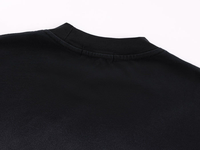 Close-up of black crew neck collar with ribbed trim and top stitching