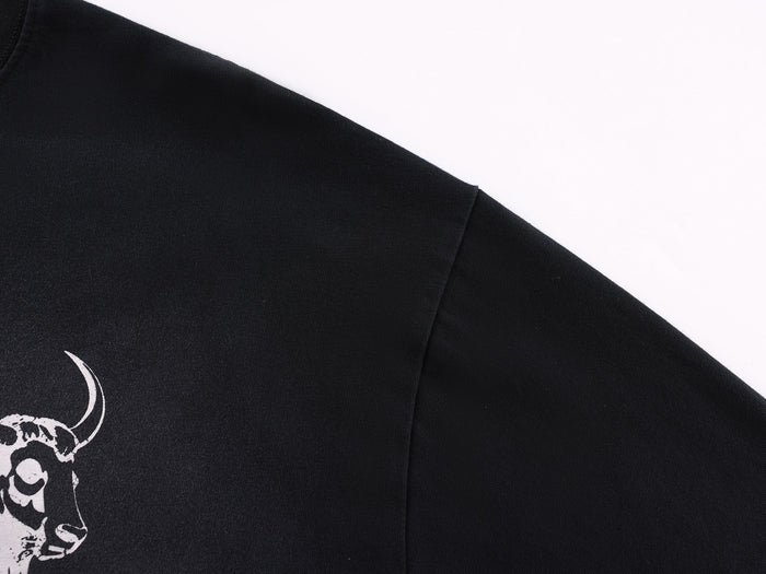 Close-up of black sleeve with partial bull graphic near the shoulder