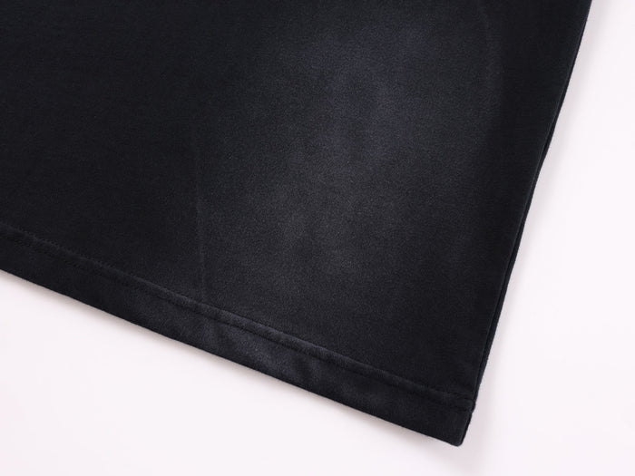 Close-up of black hem with straight stitching and soft knit texture