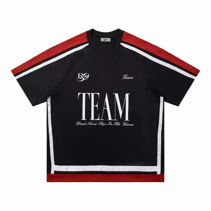 Flat lay front view of black oversized varsity mesh tee with red and white stripe accents and TEAM chest graphic