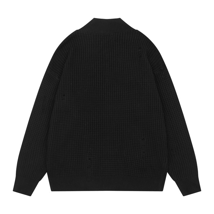 Black waffle knit cardigan, back view with distressed holes and ribbed collar