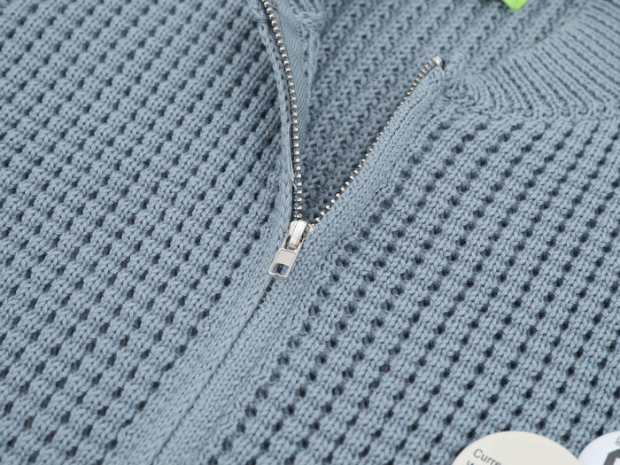 Close-up of light blue cardigan zipper and waffle knit texture