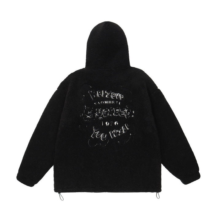Black sherpa fleece hoodie jacket shown from the back with a large outlined letter graphic and adjustable hem