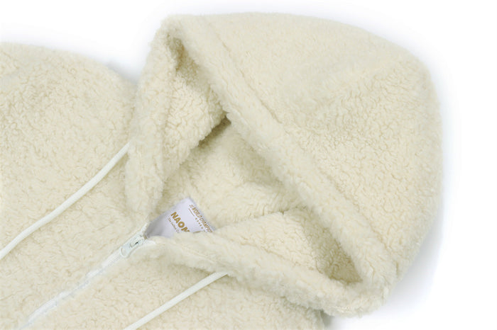 Close-up of the cream sherpa fleece hood, white drawstrings, and front zipper