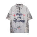 Front view of gray collared shirt with leopard-print collar and sleeve panels, graphic lettering and crosses