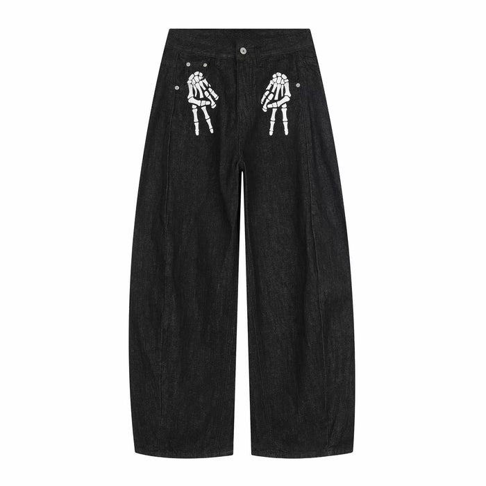 Black wide-leg denim pants with white skeleton hand graphics on the front thighs
