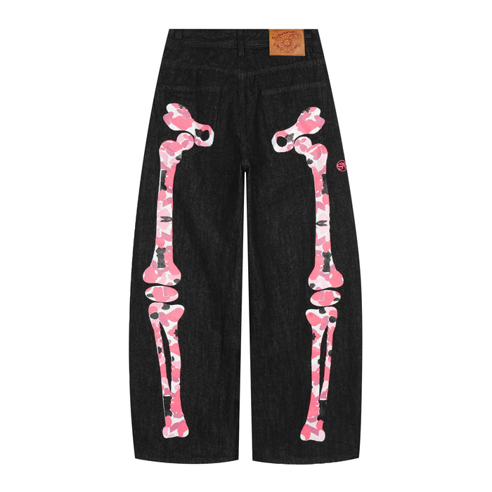Black wide-leg denim pants with pink camouflage skeleton graphics on the front legs