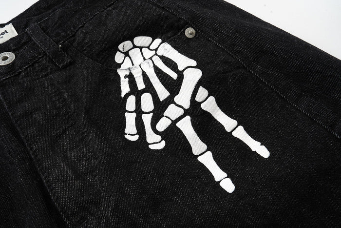 Close-up of black denim front graphic with white skeleton hand print