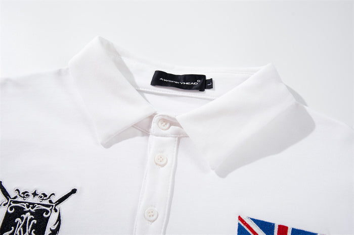 Close-up of white polo collar and button placket with crest and British flag details