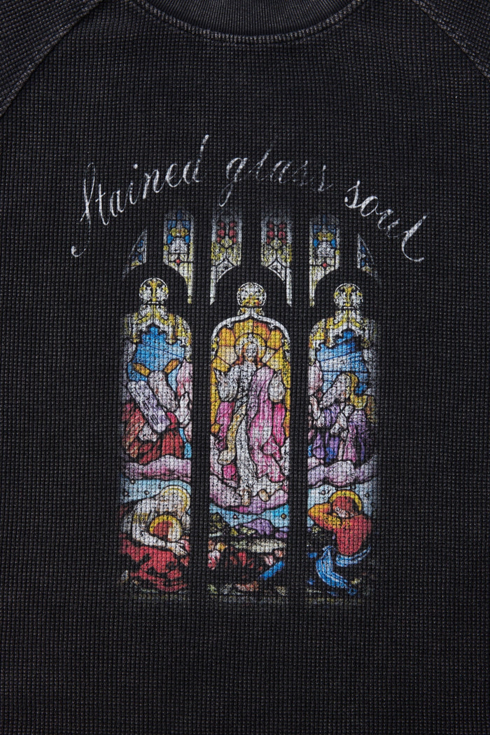 Black graphic T-shirt with colorful stained glass-style soul artwork and curved handwritten text on the chest