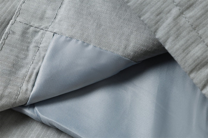 Close-up of jacket lining and inner seam beneath the outer shell