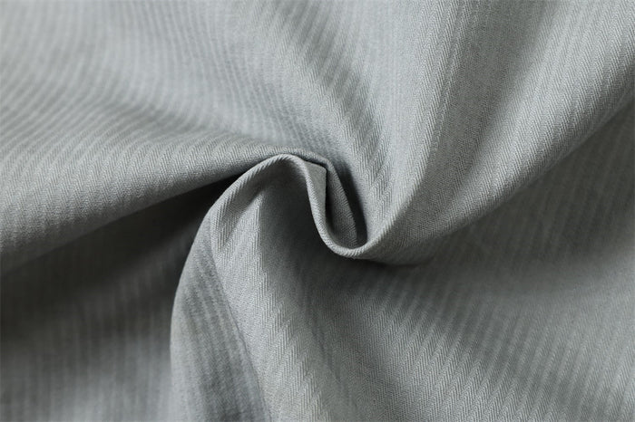 Close-up of light gray corduroy-like fabric with soft folded texture