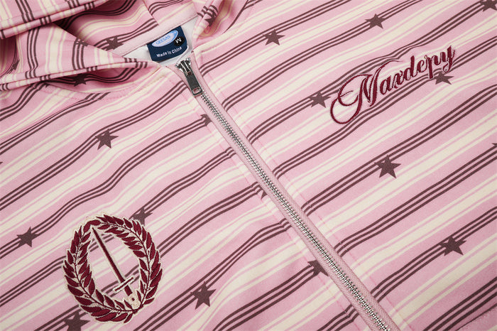 Pink striped hoodie chest detail with metal zipper, laurel emblem, and embroidered script graphic