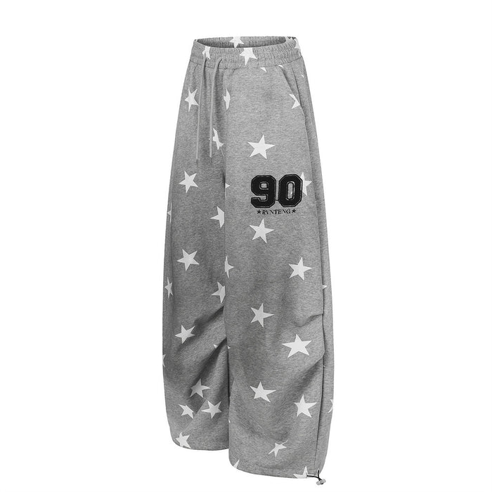 Gray star print wide-leg sweatpants with number 90 graphic, angled front view