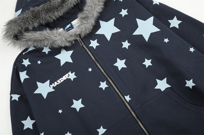 Close-up of navy star-print hoodie front showing gray fur hood trim, metal zipper, and chest logo