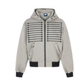 Oversized zip-up hoodie with embroidered star and stripe graphic on chest, brass zipper, metal eyelets, and ribbed black hem