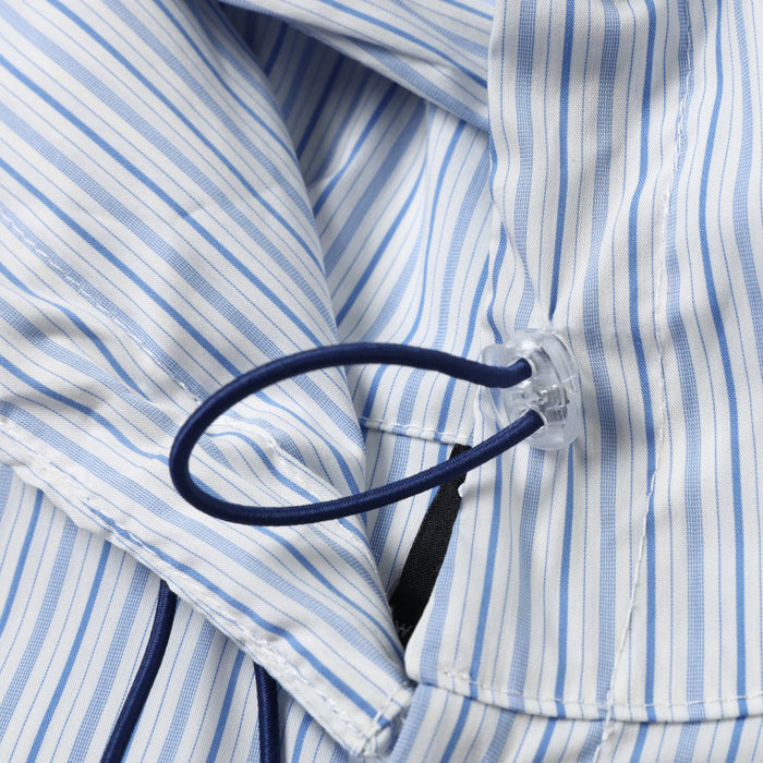 Close-up of the hood drawstring and button placket on a blue striped shirt