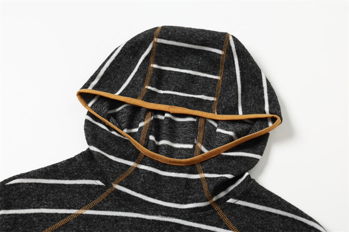 Close-up of the black pullover hood showing white stripes, soft fleece texture, and tan trim