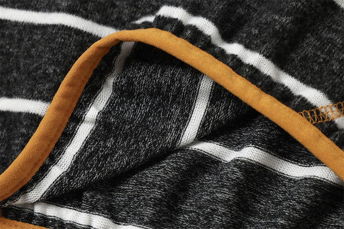 Close-up of the pullover hood edge showing tan trim, striped fleece, and visible interior fabric