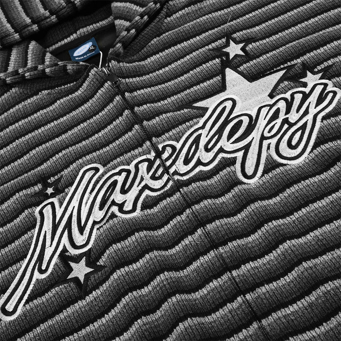 Close-up of the striped knit chest with large white outlined script lettering and star graphics