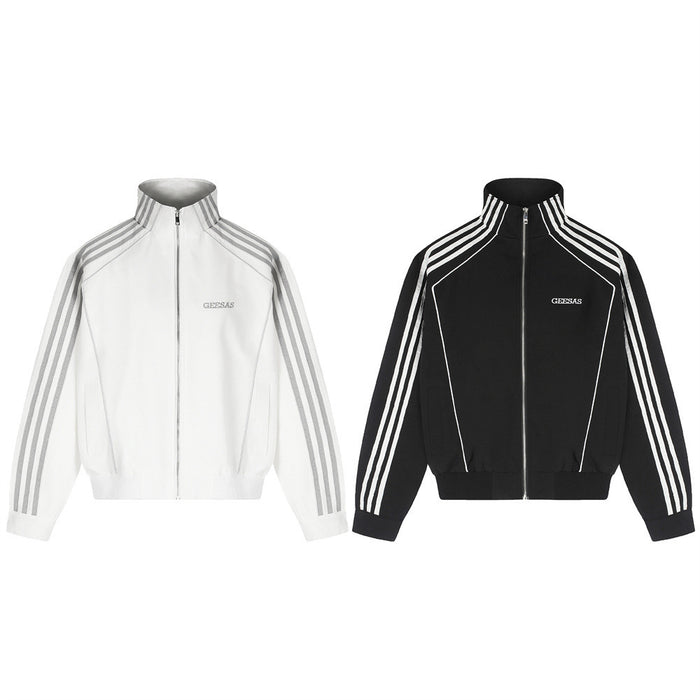 White and black mock neck track jackets shown from the front with three sleeve stripes and zip closures