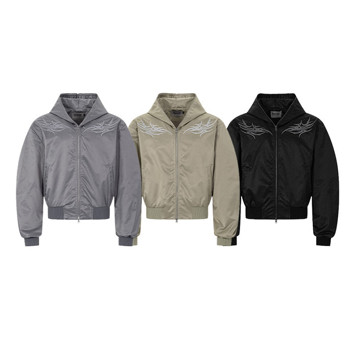 Three hooded bomber jackets in gray, beige, and black with matching light embroidered chest graphics