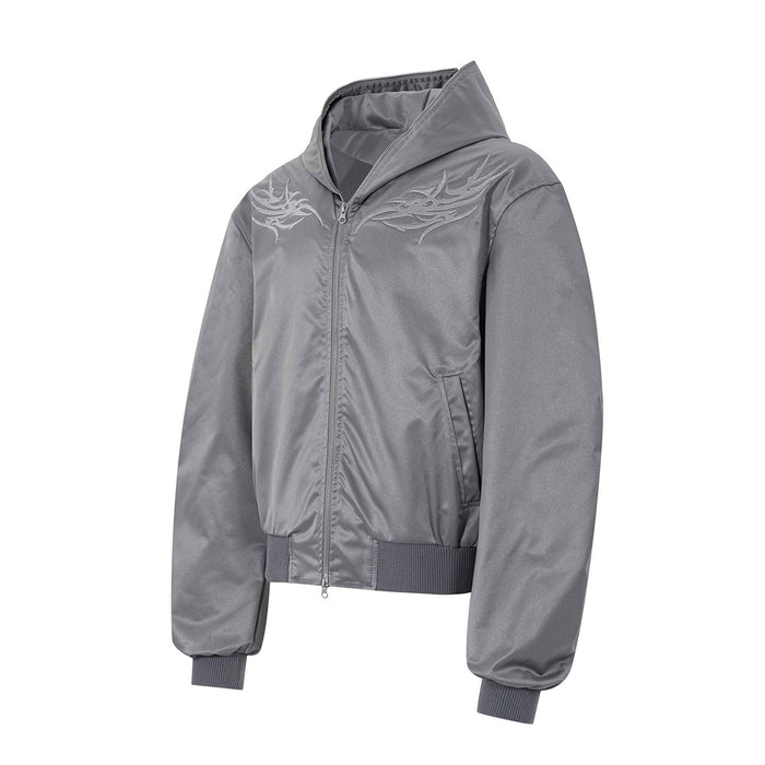 Gray hooded bomber jacket shown from a front three-quarter angle with embroidered chest graphics and ribbed cuffs