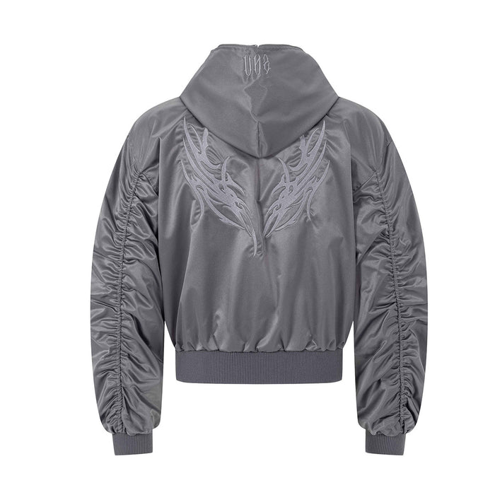 Back view of gray hooded bomber jacket with large embroidered wing-like graphic and gathered sleeves